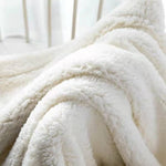 Dobbeltsidet fløjlsplaid med sherpa-fleece over sofa