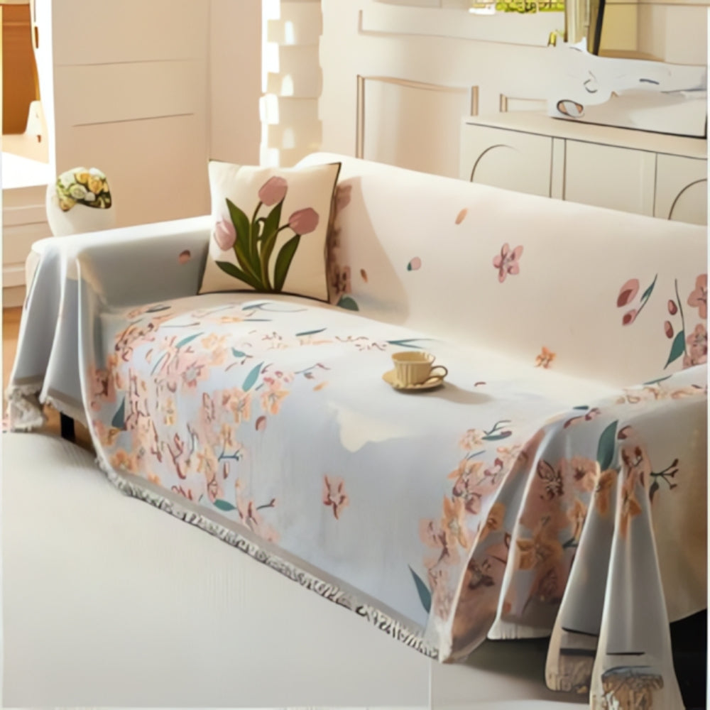 Vendbart sofabetræk med blomsterjacquard og kvaster på sofa