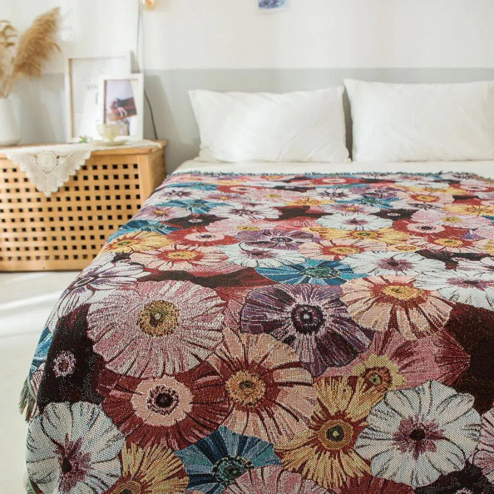 Vævet bomuldstæppe med blomster og kvaster i vintagestil over en sofa