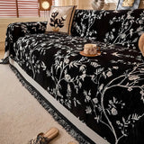 Elegant chenille sofabetræk med blomstermotiv og kvaster på sofa