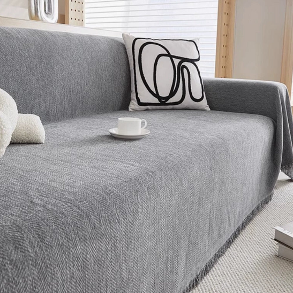 Vandafvisende sofabetræk i chenille med kvaster på sofa