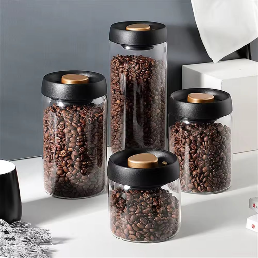 Lufttæt vakuumbeholder i klart glas med kaffebønner på køkkenbord