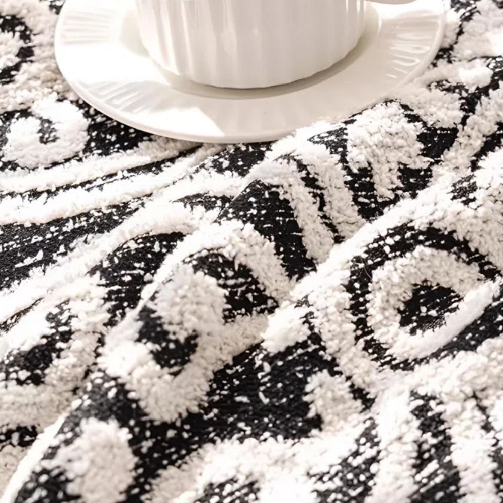 Sofabetræk i jacquard med ornamentmønster og frynsede kanter på sofa