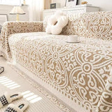 Sofabetræk i jacquard med ornamentmønster og frynsede kanter på sofa