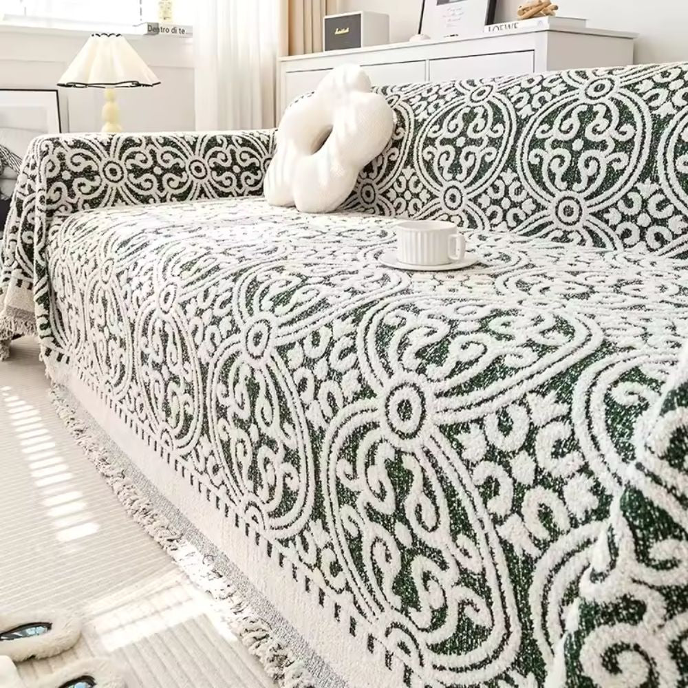 Sofabetræk i jacquard med ornamentmønster og frynsede kanter på sofa