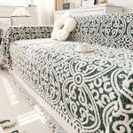 Sofabetræk i jacquard med ornamentmønster og frynsede kanter på sofa