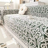 Sofabetræk i jacquard med ornamentmønster og frynsede kanter på sofa