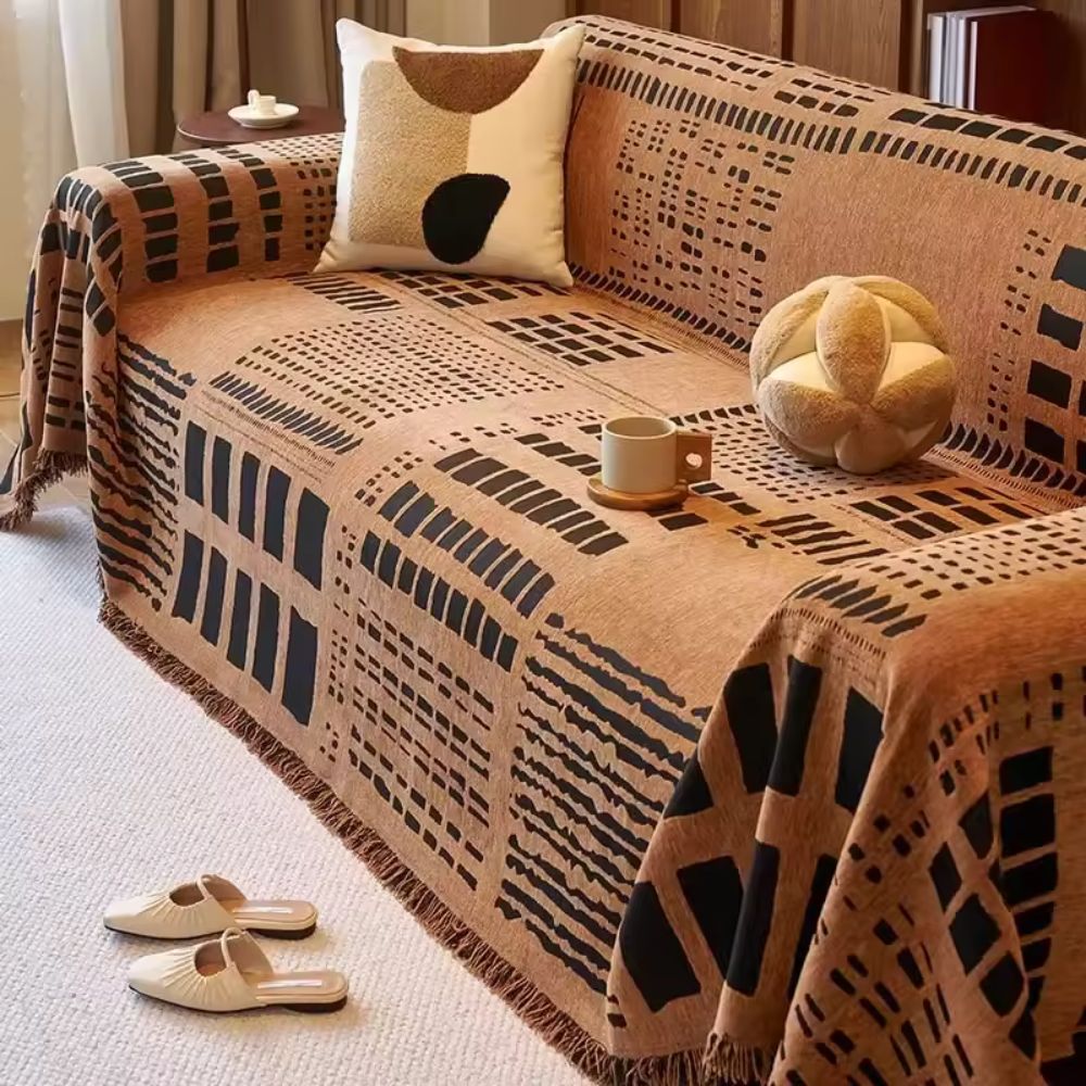 Vendbart sofabetræk i chenille med geometrisk print på sofa