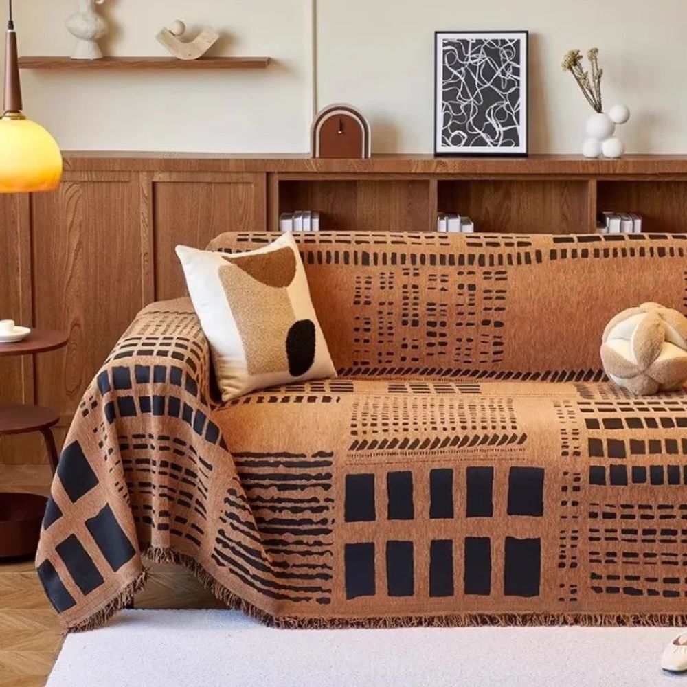 Vendbart sofabetræk i chenille med geometrisk print på sofa