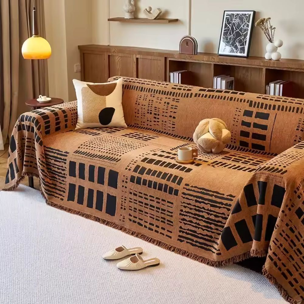 Vendbart sofabetræk i chenille med geometrisk print på sofa