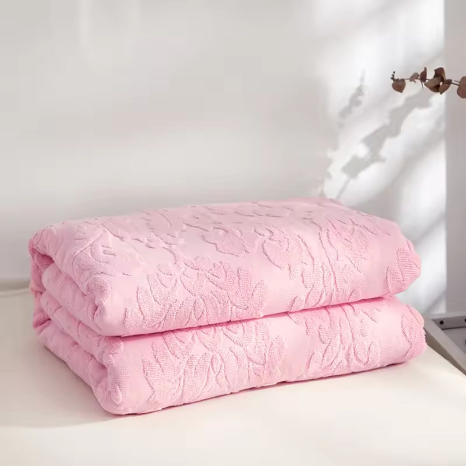 Blød plaid med blomstermønster i jacquard draperet over sofa