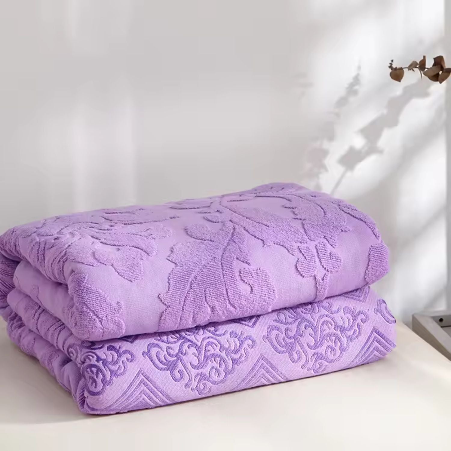 Blød plaid med blomstermønster i jacquard draperet over sofa