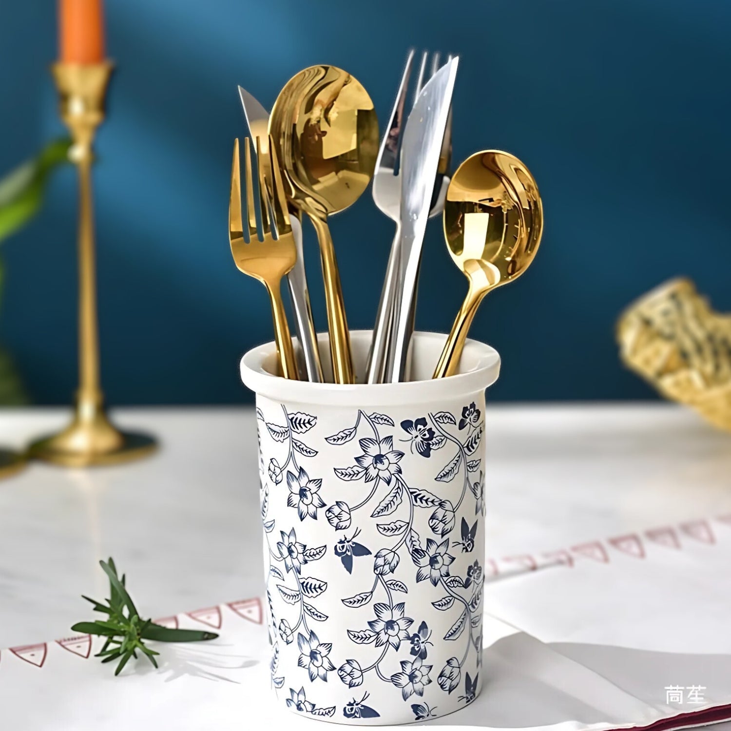 Keramisk redskabsholder med blomsterdesign og tre beholdere i køkken