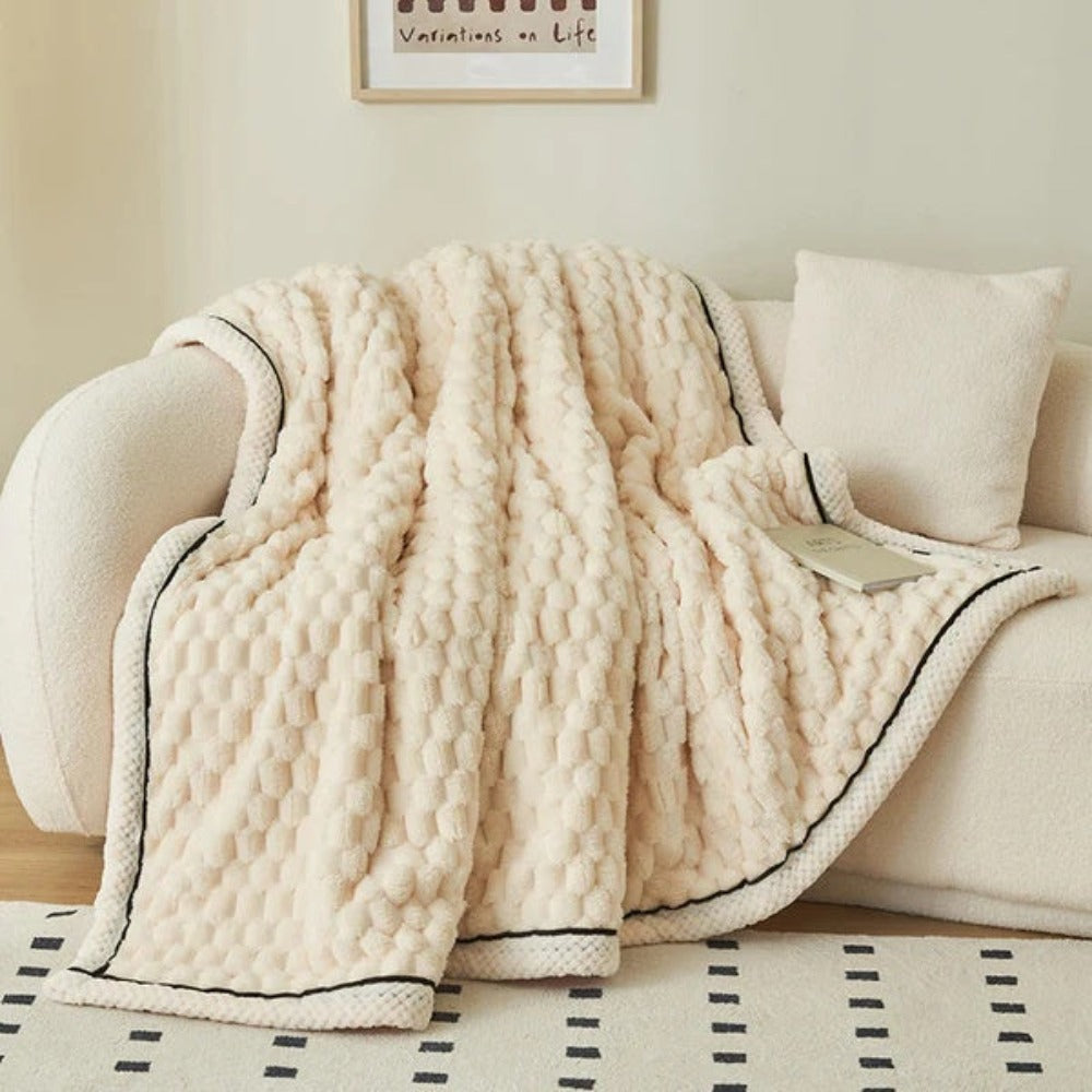 Sherpa plaid med boblemønster over sofa