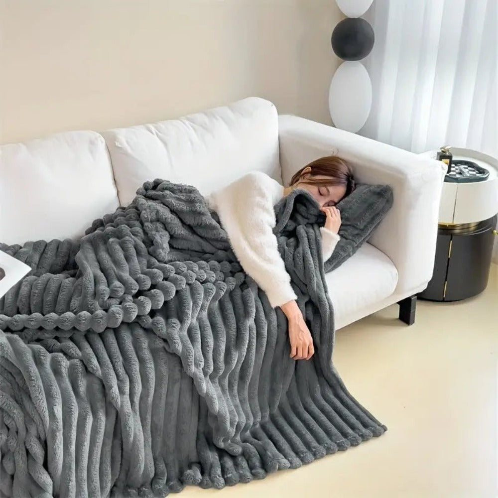 Stribet plaid i kunstpels over sofa